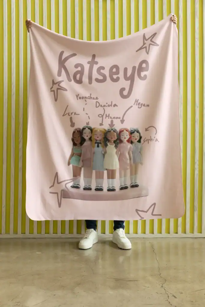 model holding katseye blanket